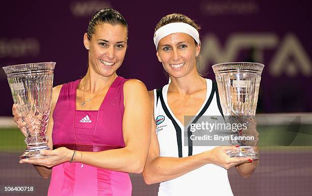 Doubles partners Flavia Pennetta of Italy and Gisela Dulko of Argentina pose with their trophies after winning the doubles final on day six of the...