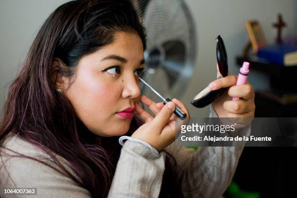 shot of a beautiful woman applying makeup. - large mirror stock pictures, royalty-free photos & images