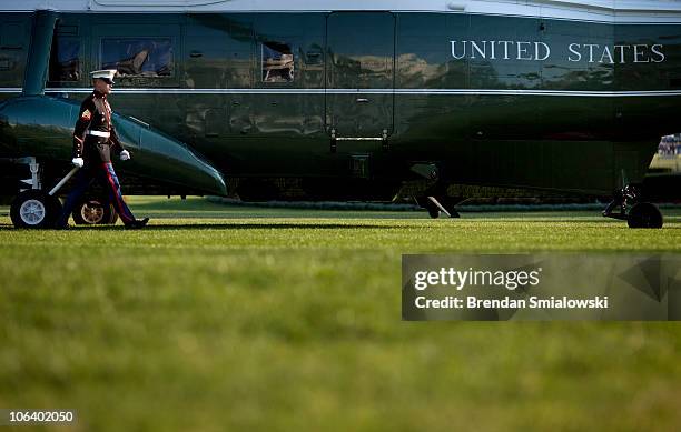 Marine walks to open the back door of Marine One on the South Lawn of the White House October 31, 2010 in Washington, DC. President Barack Obama...