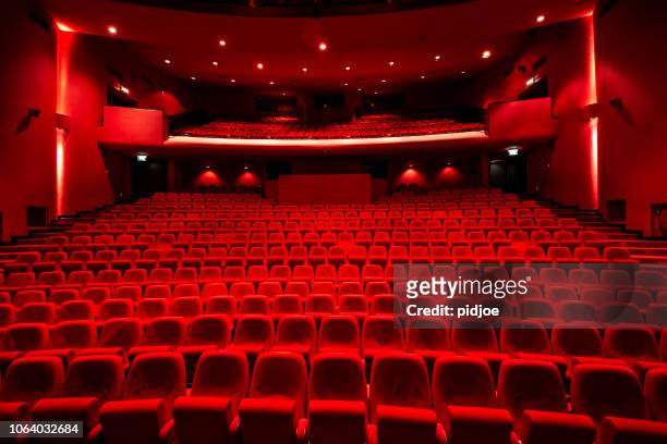 red seats in theather - film festival stock pictures, royalty-free photos & images