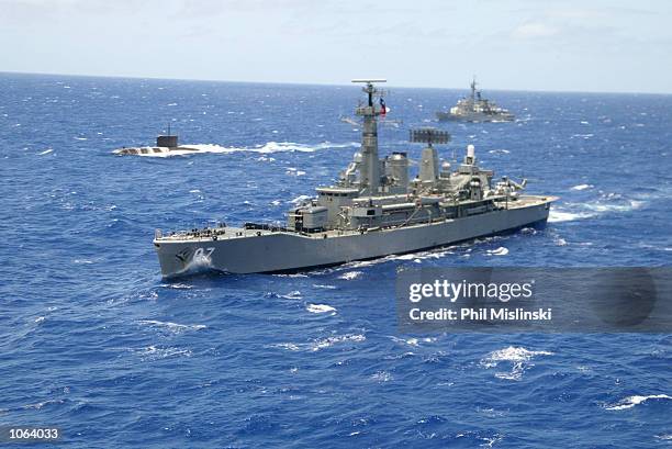 Naval ships from multiple nations steam in formation during the RIMPAC excercise operations July 11, 2002 near Oahu, Hawaii. U.S. Naval forces and...