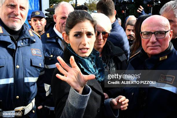 Rome mayor Virginia Raggi talks with Rome municipal police officers during the demolition of eight illegally built villas seized by Rome police to...