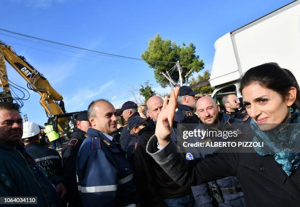 Rome mayor Virginia Raggi waves to Rome municipal police officers as she leaves after coming to view the demolition of eight illegally built villas...