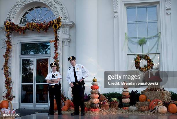 Uniformed Division Secret Service stand in front of a Halloween decorated White House October 31, 2010 in Washington, DC. President Obama and first...