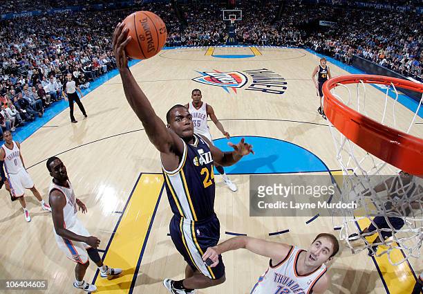 Paul Millsap of the Utah Jazz shoots over Nenad Krstic of the Oklahoma City Thunder on October 31, 2010 at the Ford Center in Oklahoma City,...