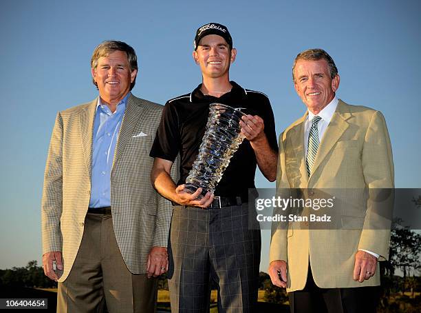 Bill Calfee, President of the Nationwide Tour, Brendan Steele, and Tim Finchem, PGA Tour Commissioner, pose for a photo on the 18th green after the...