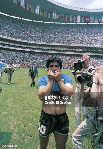 Diego Maradona of Argentina kisses his jersey after winning a 1986 FIFA World Cup Quarter Final match between Argentina and England at Azteca Stadium...