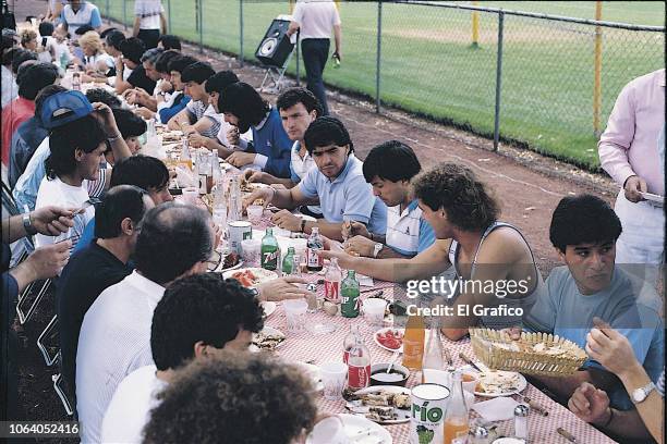 Diego Maradona of Argentina eats a barbecue with his teammates ahead of the 1986 FIFA World Cup at Club America training camp on May, 1986 in Mexico...