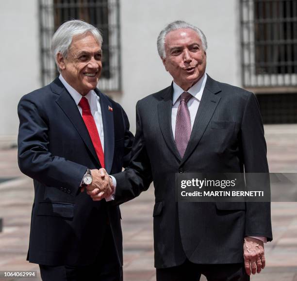 Chile's President Sebastian Pinera receives his Brazilian counterpart Michel Temer in Santiago to sign a free trade agreement between both countries,...