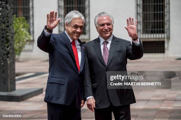 Chile's President Sebastian Pinera receives his Brazilian counterpart Michel Temer in Santiago to sign a free trade agreement between both countries,...