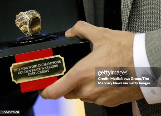 Golden State Warriors General Manager Bob Myers gives former Warrior and now Memphis Grizzlies' Omri Casspi his NBA Championship ring before their...