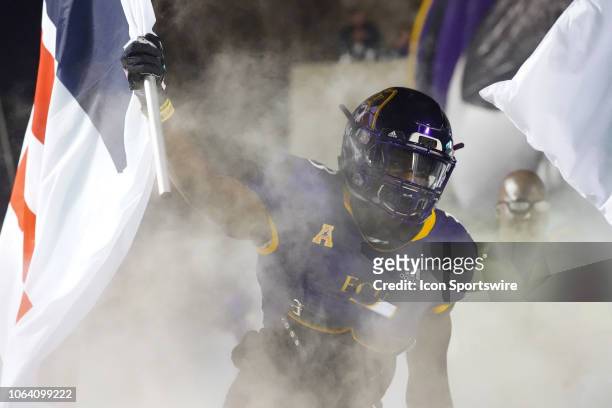 East Carolina Pirates running back Anthony Scott carries out the Power 6 flag during a game between the UConn Huskies and the East Carolina Pirates...