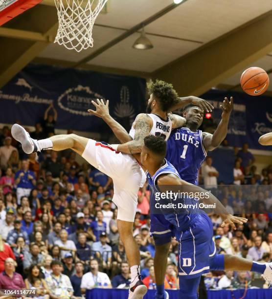 Brandon Clarke of the Gonzaga Bulldogs makes contact with Javin DeLaurier and Zion Williamson of the Duke Blue Devils before falling to the ground...