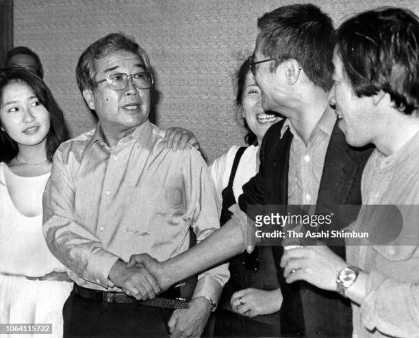 Film director Shohei Imamura and actor Ken Ogata shake hands as the film 'The Ballad of Narayama' won the Palme d'Or at Cannes Film Festival on May...