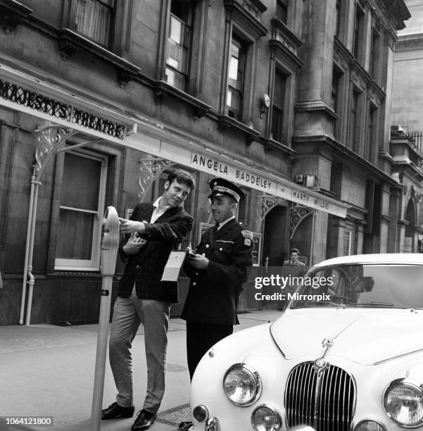 Pop star Marty Wilde is given a parking ticket after parking his cream Jaguar outside the London theatre where he is staring in the musical 'Bye Bye...