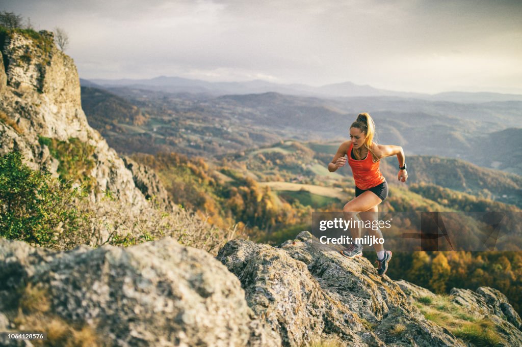 Young woman running on mountain