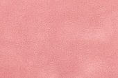 Pink matt suede fabric closeup. Velvet texture.