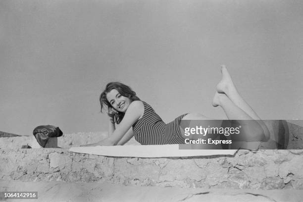 British showgirl and fashion model, Christine Keeler , known for her role in the Profumo Affair, posed wearing a swimsuit on a beach in Spain on 12th...