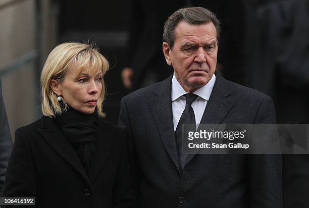 Former German Chancellor Gerhard Schroeder and his wife Doris Schroeder-Koepf depart following the memorial service for Loki Schmidt, wife of former...