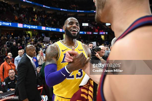 LeBron James of the Los Angeles Lakers shakes hands with Larry Nance Jr. #22 of the Cleveland Cavaliers after the game at Quicken Loans Arena on...