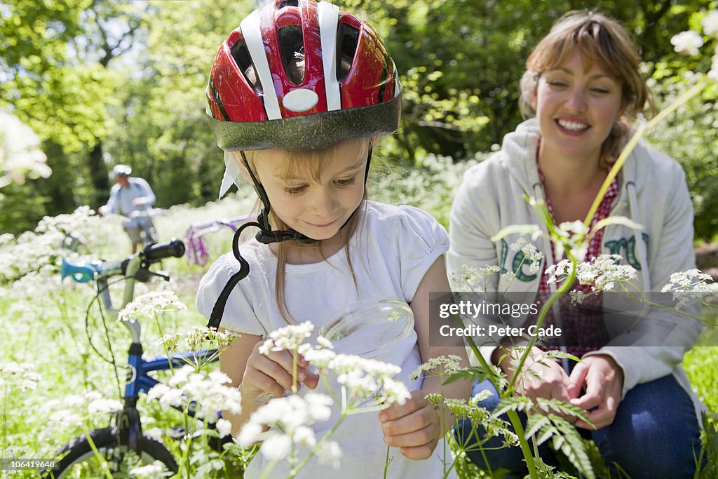 Mother and daughter viewing flower