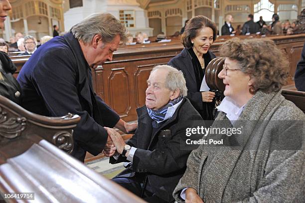 Actor Jan Fedder shake hands with German writer Siegfried Lenz during the memorial service for Loki Schmidt, wife of former German Chancellor Helmut...
