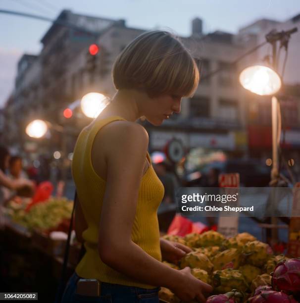 Young women shopping in NYC at a fruit market