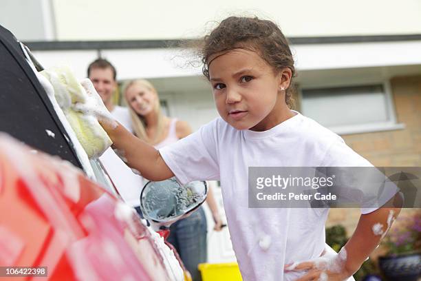 girl washing car, parents watching - girls taking a showering stockfoto's en -beelden