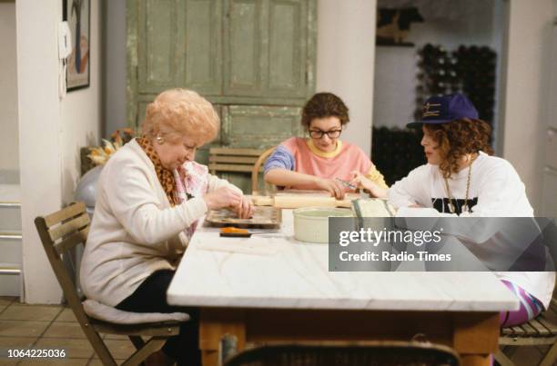 Actresses June Whitfield, Julia Sawalha and Jennifer Saunders sitting around the kitchen table in a scene from episode 'Fat' of the television sitcom...