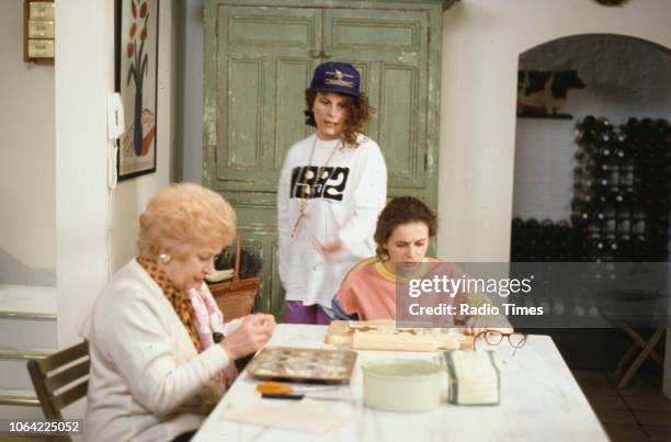 Actresses June Whitfield, Jennifer Saunders and Julia Sawalha sitting around the kitchen table in a scene from episode 'Fat' of the television sitcom...