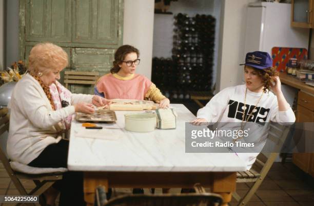 Actresses June Whitfield, Julia Sawalha and Jennifer Saunders sitting around the kitchen table in a scene from episode 'Fat' of the television sitcom...