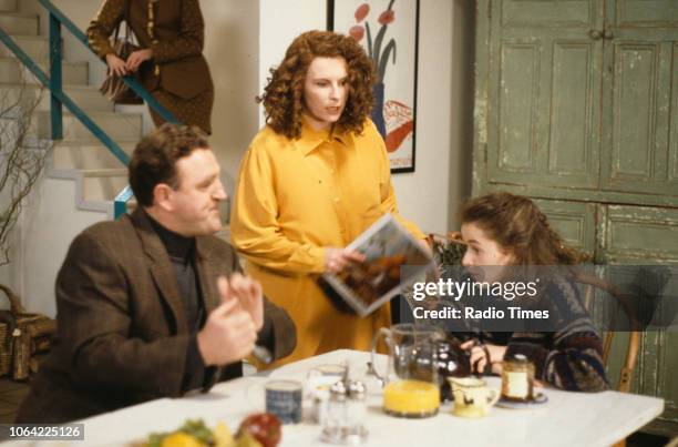 Actors Christopher Malcolm, Jennifer Saunders and Julia Sawalha sitting around the kitchen table in a scene from episode 'Fat' of the television...