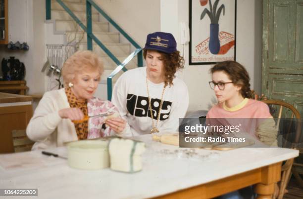Actresses June Whitfield, Jennifer Saunders and Julia Sawalha sitting around the kitchen table in a scene from episode 'Fat' of the television sitcom...