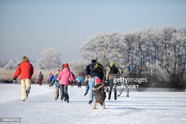 skating people on a lake in the netherlands - ice skating stock pictures, royalty-free photos & images