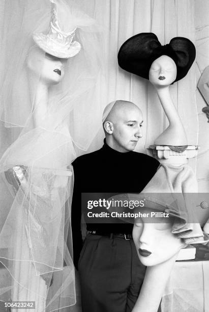 British milliner Stephen Jones, surrounded by some of his hat creations, London, circa 1985.