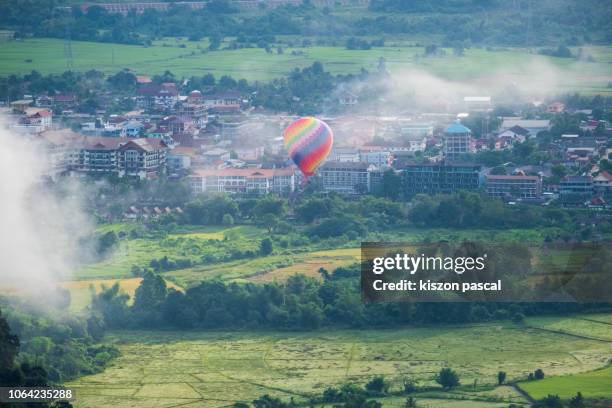 hot air balloon flying in vang vieng during morning , vientiane province , laos - vang vieng balloon stockfoto's en -beelden