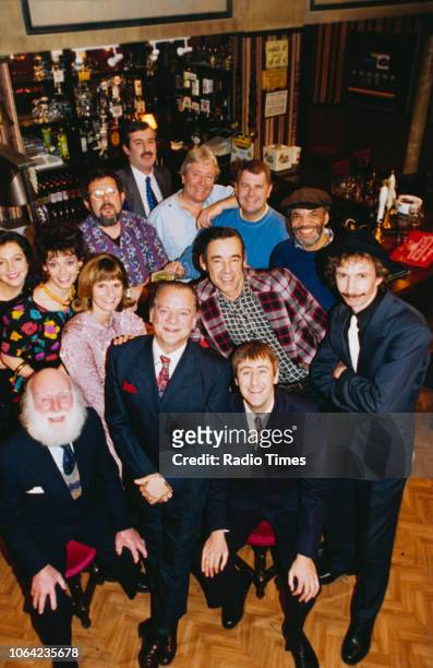 Portrait of the cast and crew on the pub set of episode 'Three Men, a Woman, and a Baby' of the BBC Television sitcom 'Only Fools and Horses'; John...