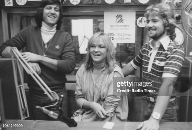 Television and radio presenters Ed Stewart, Mary Nightingale and Noel Edmonds pictured in a studio, October 1978.