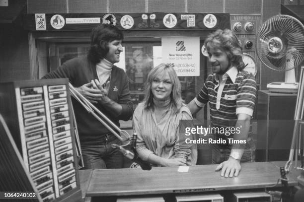 Television and radio presenters Ed Stewart, Mary Nightingale and Noel Edmonds pictured in a studio, October 1978.