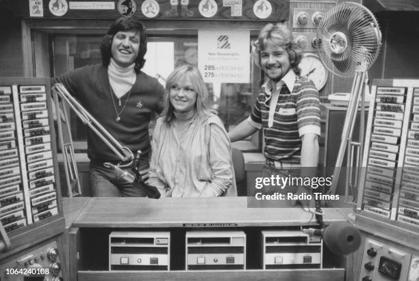Television and radio presenters Ed Stewart, Mary Nightingale and Noel Edmonds pictured in a studio, October 1978.