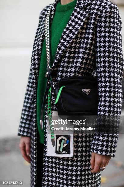 Lisa Banholzer wearing a Mango trousers, sweater from Designers Remix, Liu Jo coat, Prada bag and Mango shoes on October 28, 2018 in Berlin.