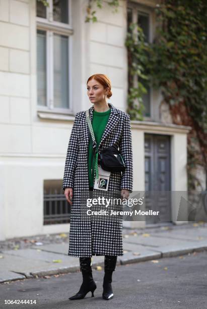 Lisa Banholzer wearing a Mango trousers, sweater from Designers Remix, Liu Jo coat, Prada bag and Mango shoes on October 28, 2018 in Berlin.