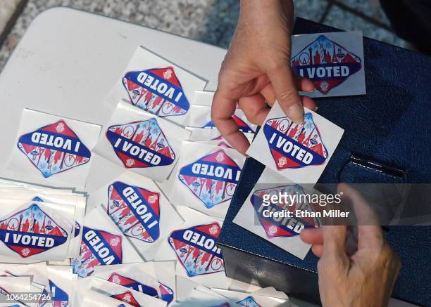 Voter receives a Las Vegas Strip-themed "I Voted" sticker after voting at the Galleria at Sunset mall on November 6, 2018 in Henderson, Nevada....