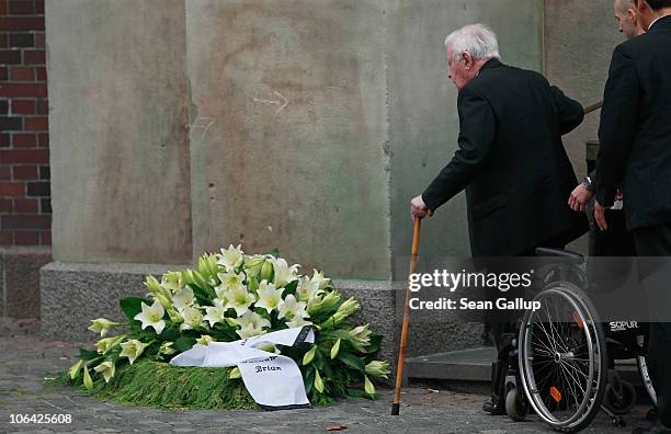 Former German Chancellor Helmut Schmidt returns to his wheelchair beside a funeral wreath after he walked down the steps following the memorial...