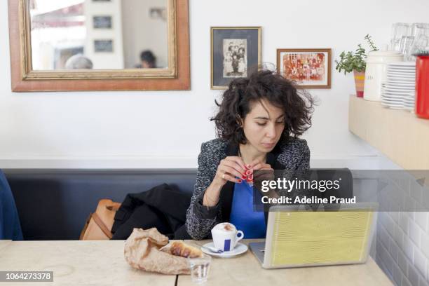 young business woman working in a cafe in france - showus office stock pictures, royalty-free photos & images