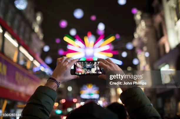 Members of the public take photos during the Oxford Street Christmas Lights switch on event at Oxford Street on November 06, 2018 in London, England.