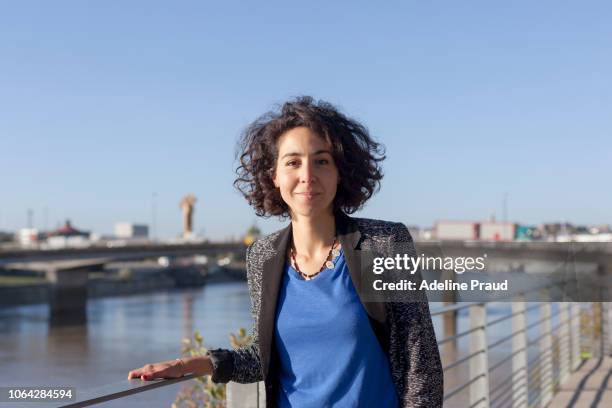 young woman on a dock in nantes. - nordafrikanischer abstammung stock-fotos und bilder