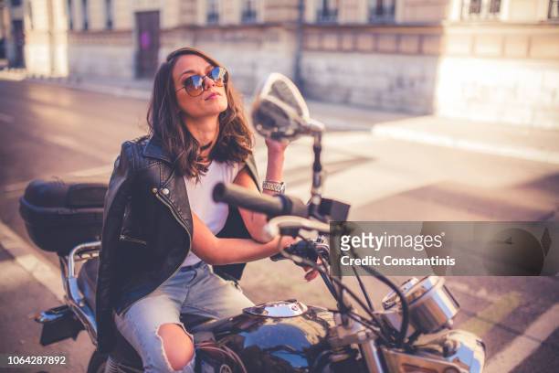 young pretty fashioned girl sitting on her motorcycle - leather dress stock pictures, royalty-free photos & images