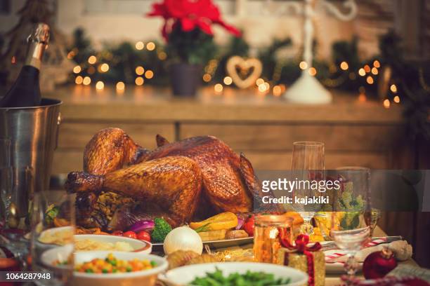 traditional stuffed christmas turkey with side dishes - christmas table turkey stock pictures, royalty-free photos & images