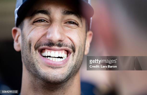 Daniel Ricciardo of Australia and Red Bull Racing laughs at the Red Bull Racing teamshot in the Pitlane during previews ahead of the Abu Dhabi...